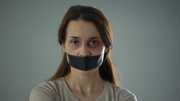 Lady With Taped Mouth and Tied Hands Silently Asking for Help, Sexual Slavery