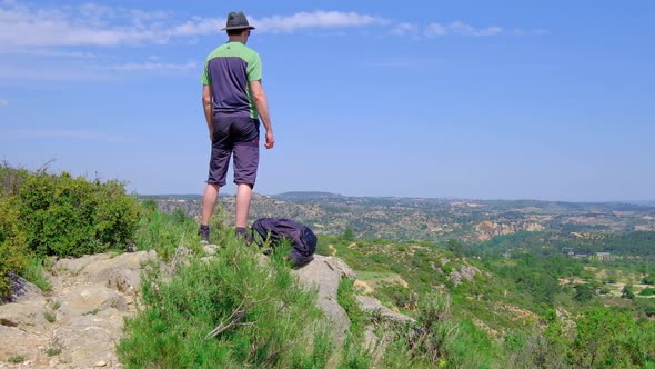 Man is Standing with a Laying Backpack