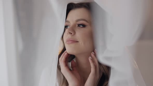 Bride in Boudoir Dress Under Veil and in a Silk Robe Wedding Morning Preparations Before Ceremony