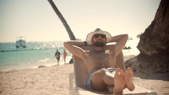 Happy Traveler Resting Beach Hotel Luxury. Man Relaxing On Tropical Beach. Man Relaxing On Tropical