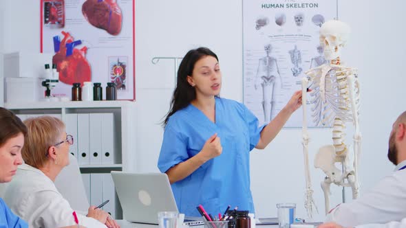 Doctor Describing the Layout of the Human Spine in Front of Colleagues