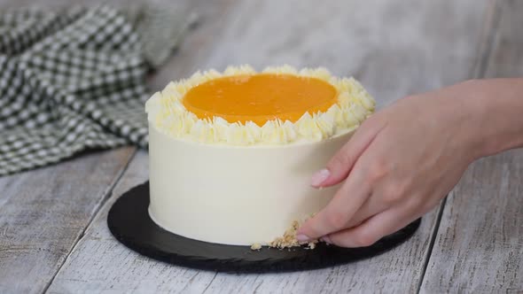 Woman Decorates Carrot Cake Chopped Walnuts