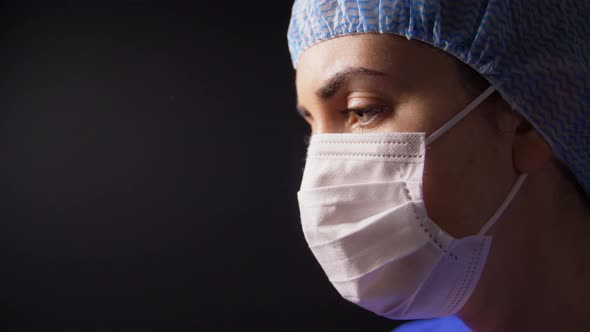 Female Doctor or Nurse in Face Mask Praying