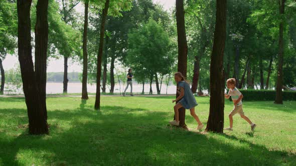 Laughing Children Running on Sunny Meadow