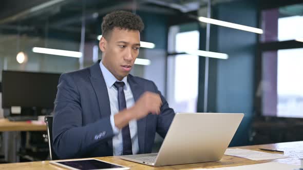 Sick Young Businessman Working on Laptop and Coughing 