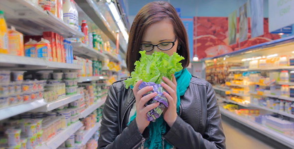 A Girl Holding a Lettuce Leaf