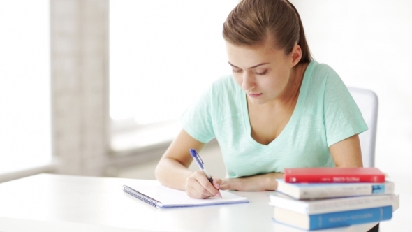 Happy Female Student Doing Homework