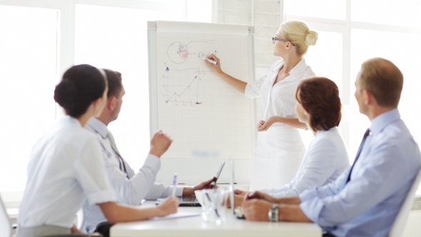Business People With Flip Board Having Meeting