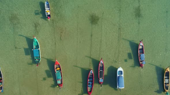 Amazing aerial Top view Longtail fishing boats in the tropical sea at Rawai beach Phuket Thailand