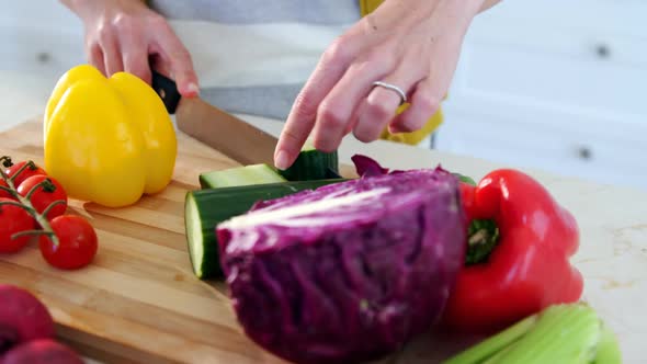 Woman chopping vegetables in the kitchen at home