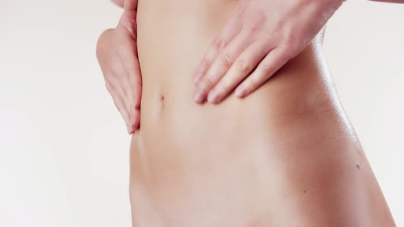 Female Applying Body Lotion on Her Belly