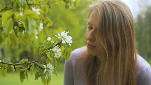 Face of woman smelling an apple flower