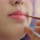 Close-up On Lips Of A Young Asian Woman. Makeup Artist Apply Lipstick To Model. - VideoHive Item for Sale