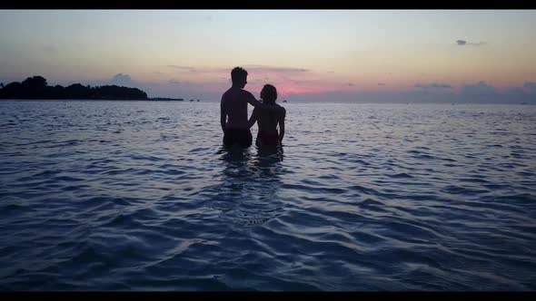 Teenage lovers relax on beautiful bay beach wildlife by transparent ocean with clean sand background