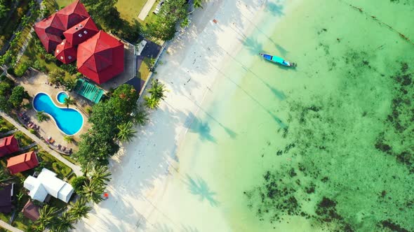 Aerial flying over texture of tranquil coastline beach voyage by turquoise lagoon and white sand bac