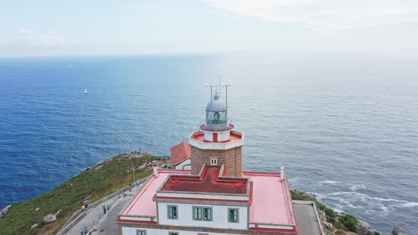 Finisterre lighthouse on Rocky cliff by the Atlantic Ocean, pilgrimage point, end of the old world.