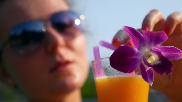 Female In Sunglasses Drinking Fresh Fruit Juice On