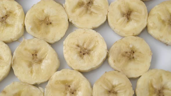 Banana Slices Closeup, Macro Food Summer Background, Fruits Top View. Rotate