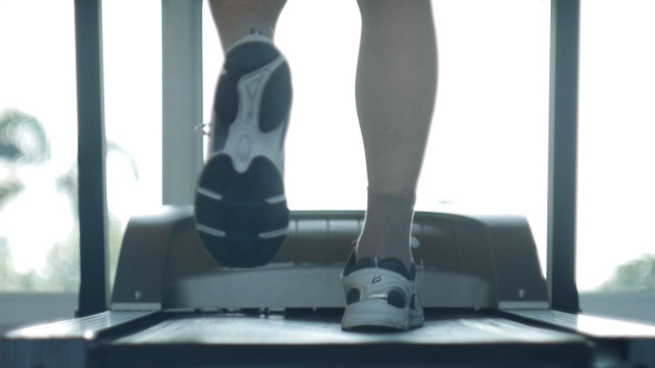 Man Running On Treadmill In Gym
