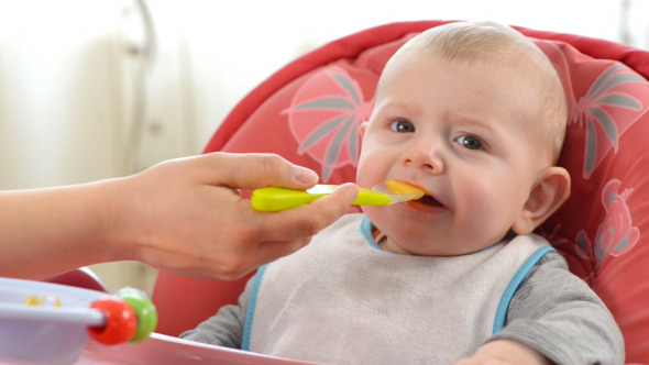 Baby Eating in a High Chair