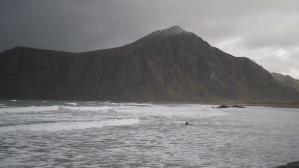 Surfer Lying On Board In Rough Sea