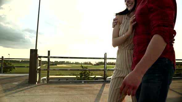 Young couple walking on parking deck