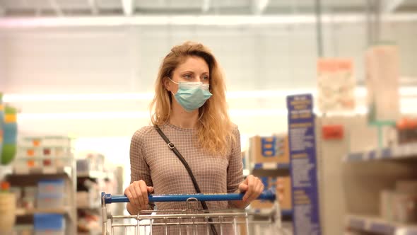 Girl Shopping In Face Mask. Woman In Shop On Pandemic Coronavirus Covid 19. Shopper In Medical Mask