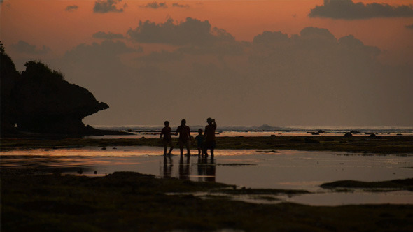 Family Walking on the Beach in Sunset