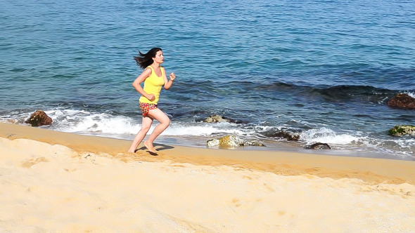 Sportive Woman Running on Beach