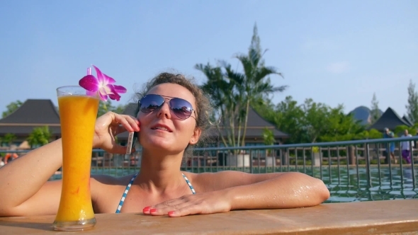 Smiling Woman Talking On The Phone And Bathing In