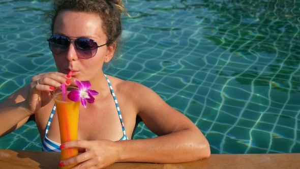 Beautiful Girl In Sunglasses Drinking Mango Juice