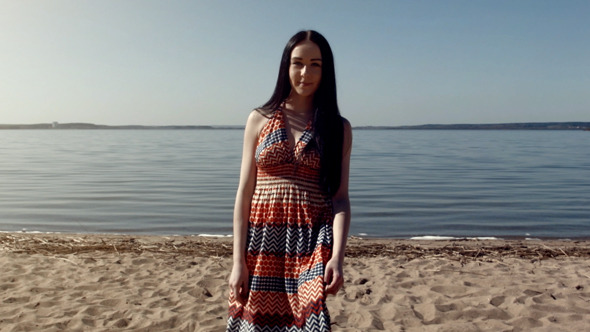 Young Woman Walking Near The Sea