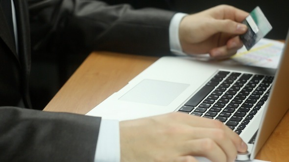 Businessman Using Credit Card for Online Payment