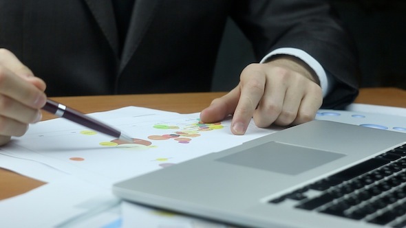  Businessman Examining Business Graph alt