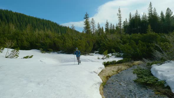 Young Woman with a Backpack Travels in the Mountains