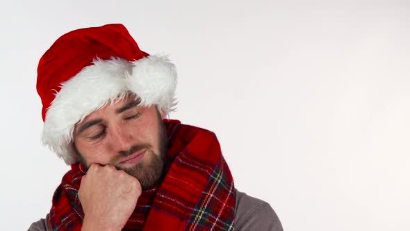 Young Man in Christmas Santa Hat Looking Upset