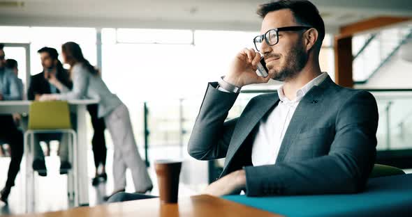 Happy Businessman Relaxing in Cafe