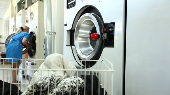 Woman Gets Clean Clothes From Washing Machine