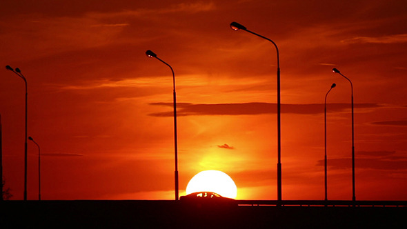 Cars Silhouettes On Road Against Sunset
