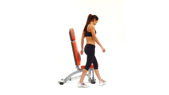 Slim Brunette Woman On Hydraulic Exerciser