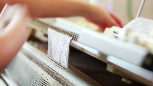 Machine Operator Removes Finished Knitting alt