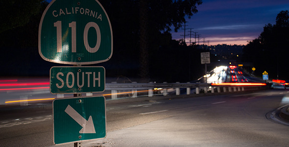 Night Traffic Rushes past Onramp Sign