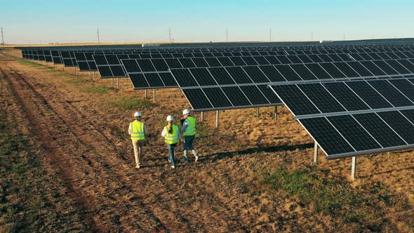 Three Engineers Working at Solar Farm