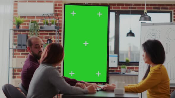 Coworkers Meeting in Office with Green Screen on Monitor Vertically