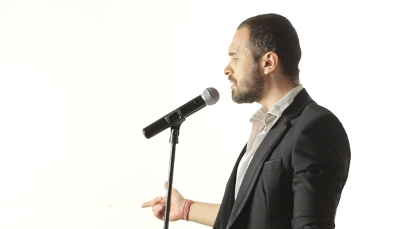 Brutal Man With a Beard Sings Into The Microphone