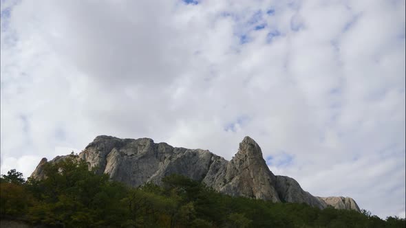 Mountains Against the Blue Sky with White Clouds. Cirrus Clouds Run Across the Blue Sky.