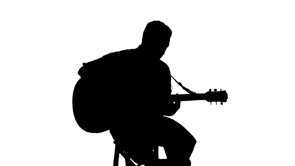 Silhouette Of Sitting Man Playing The Guitar On a