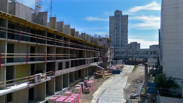 Builders are installing reinforcing bars on a sunny summer day. Copter footage alt