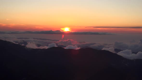 Sunset From the Misty and Cloudy Mountain Peak