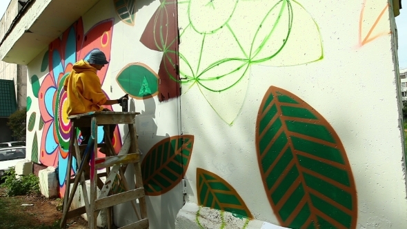 View Of Graffiti Artist Working On Street alt